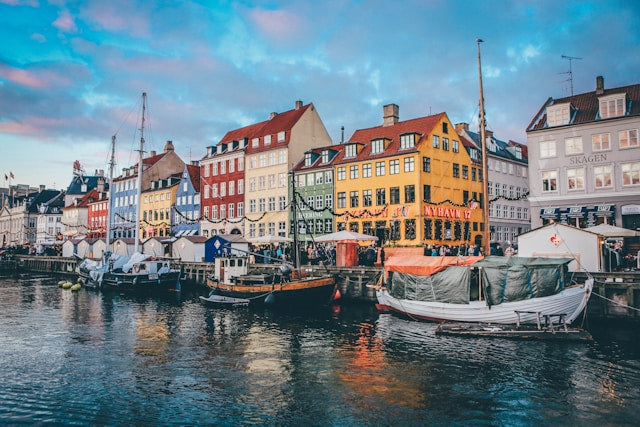 Scenic Nordic city waterfront with colorful historic buildings and canal reflecting Scandinavian architecture